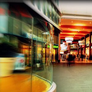 Explore the lively atmosphere of a modern shopping mall in Hoofddorp, Netherlands, captured with vibrant colors and motion blur.